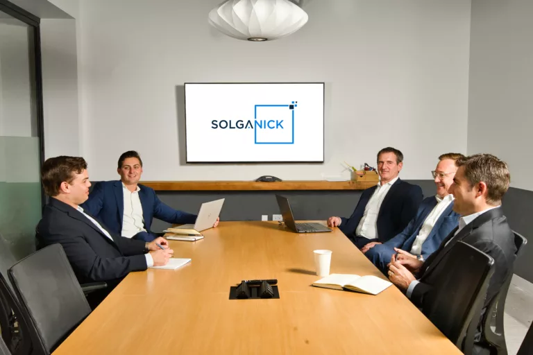 Solganick deal team in conference room